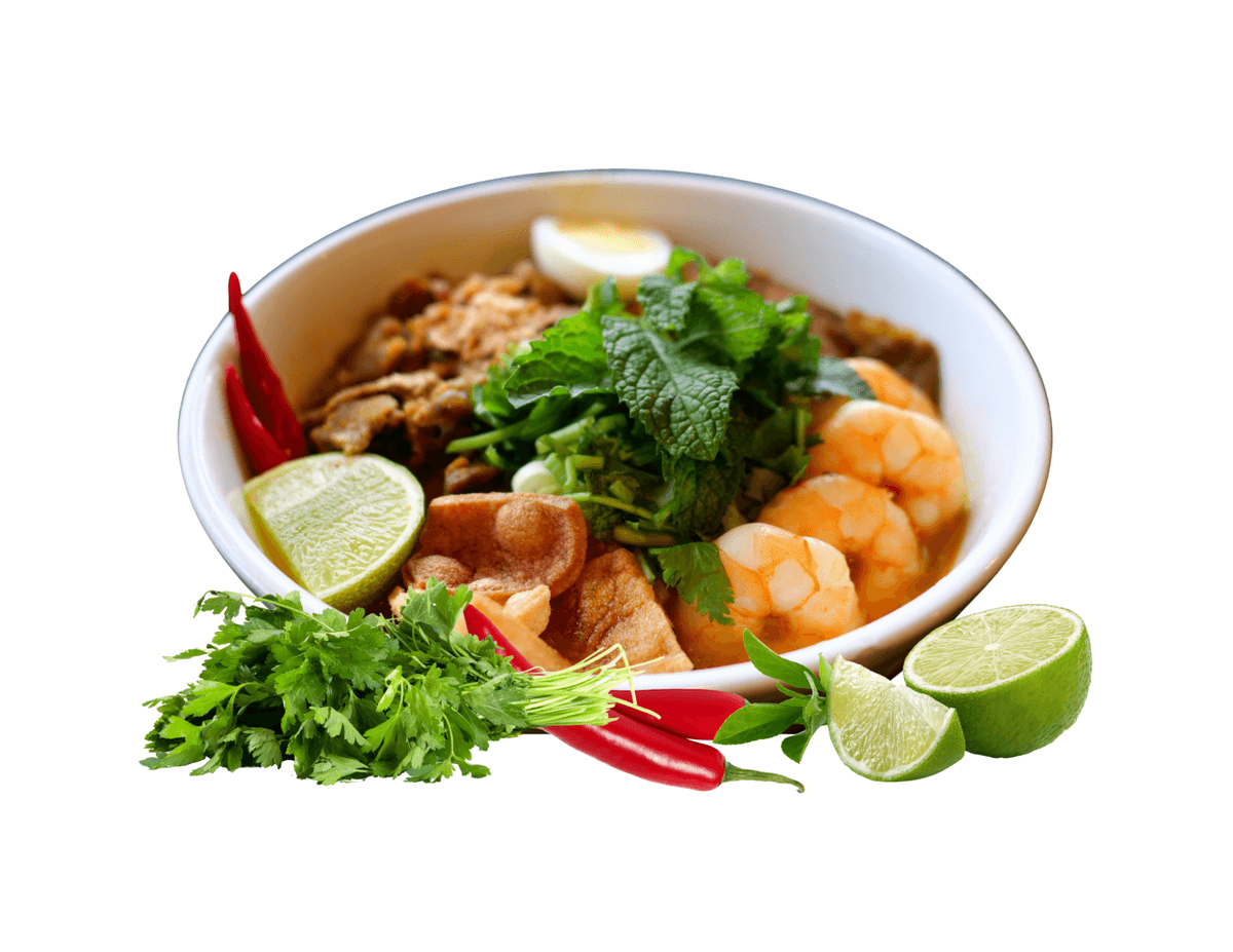 A bowl of Mi Quang with shrimp, herbs, lime and red chili