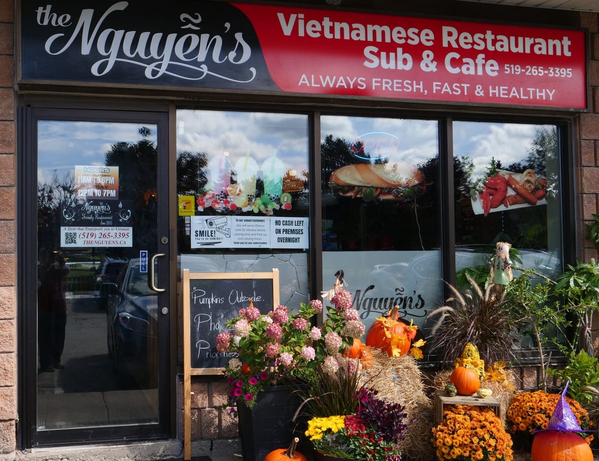The Nguyen's storefront on Speedvale Avenue, with its red sign and autumn flowers by the door